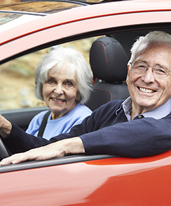 Image of an older couple driving